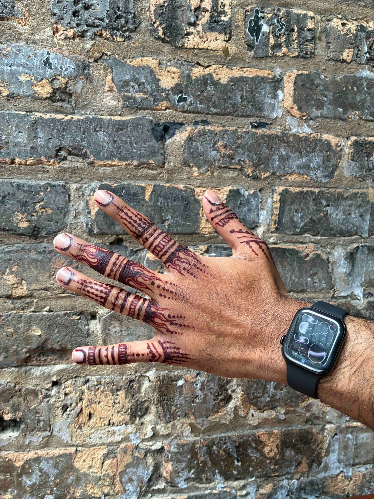 Vertical flame motifs running down each finger on the back of a hand